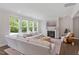 Inviting living room with large windows, fireplace, and a comfortable white sectional sofa at 74 Permit Ct, Chapel Hill, NC 27517