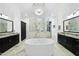 This luxurious bathroom showcases a standalone tub, dual vanities, and an elegant chandelier at 7545 Hasentree Club Dr, Wake Forest, NC 27587