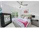 Bright bedroom with large black framed mirror, ceiling fan and ample natural light at 7545 Hasentree Club Dr, Wake Forest, NC 27587