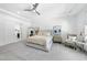 Spacious bedroom with a tray ceiling, fan, neutral walls and carpet, and access to en-suite bath and closet at 7545 Hasentree Club Dr, Wake Forest, NC 27587