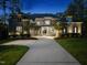 Stunning stone home exterior featuring elegant architectural details and a lush, landscaped yard at 7545 Hasentree Club Dr, Wake Forest, NC 27587