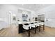 Modern kitchen featuring white cabinets, stainless steel appliances, a large island, and hardwood floors at 7545 Hasentree Club Dr, Wake Forest, NC 27587