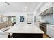 Well-appointed kitchen featuring a large island with marble countertops, modern fixtures, and stainless appliances at 7545 Hasentree Club Dr, Wake Forest, NC 27587