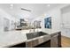 Close-up of a kitchen island featuring marble countertops, stainless steel sink, and an open-concept layout at 7545 Hasentree Club Dr, Wake Forest, NC 27587