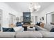 Stylish living room showcasing modern decor, a fireplace, and an open layout to the kitchen and dining area at 7545 Hasentree Club Dr, Wake Forest, NC 27587