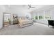Serene bedroom with natural light, neutral tones, a ceiling fan, and a spacious layout at 7545 Hasentree Club Dr, Wake Forest, NC 27587