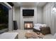 Cozy outdoor living room with fireplace and TV overlooking lush backyard at 7545 Hasentree Club Dr, Wake Forest, NC 27587