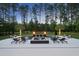 Luxury swimming pool with integrated spa, water features, and lounge areas at night at 7545 Hasentree Club Dr, Wake Forest, NC 27587
