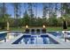 Stunning backyard pool with waterfall features and lounge area at 7545 Hasentree Club Dr, Wake Forest, NC 27587