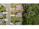 Aerial view features homes with landscaped yards and private driveways bordering a dense wooded area, providing privacy and nature at 8132 Wheeler Woods Dr, Apex, NC 27539