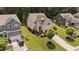 Aerial view of a neighborhood featuring well-manicured lawns, mature trees, and diverse home styles on a sunny day at 8132 Wheeler Woods Dr, Apex, NC 27539