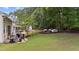 Large backyard featuring a patio area, outdoor seating, and well-maintained landscaping at 8132 Wheeler Woods Dr, Apex, NC 27539