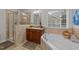 Beautiful bathroom with a walk-in shower, bathtub, and stylish vanity at 8132 Wheeler Woods Dr, Apex, NC 27539