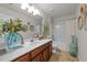 Bright bathroom featuring a vanity, large mirror, and shower-tub combination at 8132 Wheeler Woods Dr, Apex, NC 27539