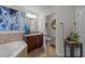 Well-appointed bathroom with a vanity, mirror, and bathtub at 8132 Wheeler Woods Dr, Apex, NC 27539