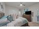 Relaxing bedroom with a ceiling fan, plush bedding, and an accent wall decor at 8132 Wheeler Woods Dr, Apex, NC 27539
