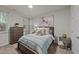 Cozy bedroom featuring a queen-size bed, soft carpet, and an oversized dresser at 8132 Wheeler Woods Dr, Apex, NC 27539