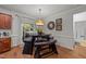 Cozy dining area with a unique table and bench seating, complemented by natural light at 8132 Wheeler Woods Dr, Apex, NC 27539