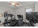Well-equipped exercise room with treadmill, stationary bike, and a ceiling fan at 8132 Wheeler Woods Dr, Apex, NC 27539