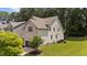 Two-story home with brick and vinyl siding, showing a well-maintained lawn and mature trees surrounding the property at 8132 Wheeler Woods Dr, Apex, NC 27539