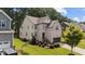 Two-story home featuring brick and vinyl siding, manicured lawn, landscaping, and a two-car garage on a sunny day at 8132 Wheeler Woods Dr, Apex, NC 27539