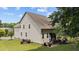 Exterior view of the home highlighting a spacious backyard, screened porch, and well-maintained landscape at 8132 Wheeler Woods Dr, Apex, NC 27539