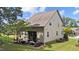Back exterior of the home showcasing the screened porch, neat landscaping, and well-maintained siding at 8132 Wheeler Woods Dr, Apex, NC 27539
