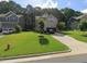 Charming brick two-story home with a well-maintained lawn and a long driveway at 8132 Wheeler Woods Dr, Apex, NC 27539