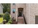 Close-up of the front entrance with brick stairs and manicured landscaping at 8132 Wheeler Woods Dr, Apex, NC 27539
