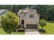 Charming brick home featuring well-maintained landscaping and a two-car garage at 8132 Wheeler Woods Dr, Apex, NC 27539