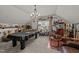 Spacious game room with a pool table, bar, and comfortable seating area at 8132 Wheeler Woods Dr, Apex, NC 27539