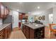 Large kitchen island with granite countertops and stainless steel appliances, opening to dining area at 8132 Wheeler Woods Dr, Apex, NC 27539