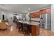 Kitchen island overlooking the living area with granite countertops and stainless steel appliances at 8132 Wheeler Woods Dr, Apex, NC 27539
