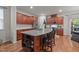 Kitchen island featuring granite countertops, stainless appliances, and seating at 8132 Wheeler Woods Dr, Apex, NC 27539