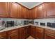 Kitchen corner features granite counters, subway tile backsplash, and dark brown cabinets at 8132 Wheeler Woods Dr, Apex, NC 27539