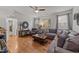 Comfortable living room with wood floors, neutral gray walls, and a large sectional sofa at 8132 Wheeler Woods Dr, Apex, NC 27539