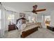 Comfortable main bedroom showcasing a king-size bed, fan, and neutral tones at 8132 Wheeler Woods Dr, Apex, NC 27539