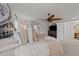 Main bedroom with tufted headboard, soft bedding, and view to en suite bathroom at 8132 Wheeler Woods Dr, Apex, NC 27539