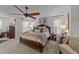 Spacious main bedroom featuring a king-size bed, ceiling fan, and neutral tones at 8132 Wheeler Woods Dr, Apex, NC 27539