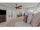 Comfortable main bedroom featuring a plush bed, ceiling fan, and open en suite bathroom at 8132 Wheeler Woods Dr, Apex, NC 27539