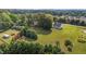 Expansive aerial view of property with lush landscaping, long driveway and above ground pool at 820 Water Plant Rd, Zebulon, NC 27597