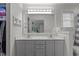 Bright bathroom features a double sink vanity and a large mirror reflecting the bedroom at 820 Water Plant Rd, Zebulon, NC 27597