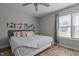 Neutral bedroom with modern decor, ceiling fan, and a bright window at 820 Water Plant Rd, Zebulon, NC 27597