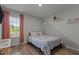 Cozy bedroom with light walls, whimsical cloud decor, and a large window at 820 Water Plant Rd, Zebulon, NC 27597