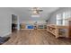 Spacious bonus room offering wood-look flooring, ceiling fan, storage shelves and work area at 820 Water Plant Rd, Zebulon, NC 27597