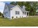 Landscaped yard and inviting covered porch accentuates the side exterior of this single-Gathering home at 820 Water Plant Rd, Zebulon, NC 27597