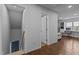 Hallway leads to staircase, door and room with built-in shelving by window at 820 Water Plant Rd, Zebulon, NC 27597