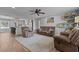 Bright and open living room with modern ceiling fan, comfortable seating, and view into the kitchen at 820 Water Plant Rd, Zebulon, NC 27597