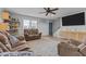 Cozy living room with ceiling fan, large rug, and comfortable furniture and a view to the front entrance at 820 Water Plant Rd, Zebulon, NC 27597