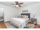 Bright bedroom with neutral decor, ceiling fan, and a large window overlooking the backyard at 828 Cotton Pl, Raleigh, NC 27601